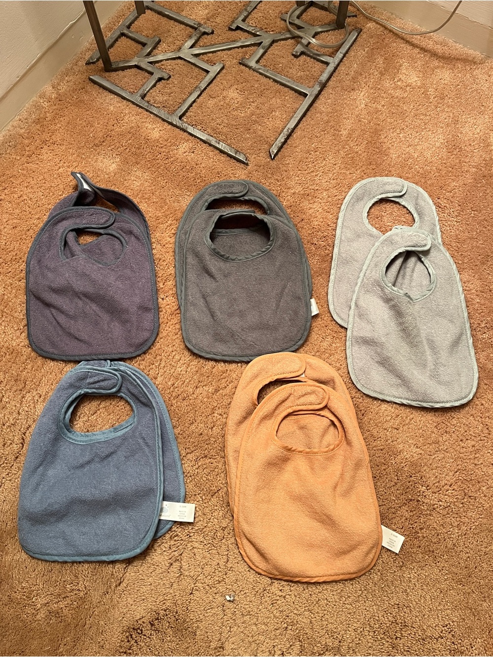 cloud island baby bibs in purple, gray, blue, tan, and cream